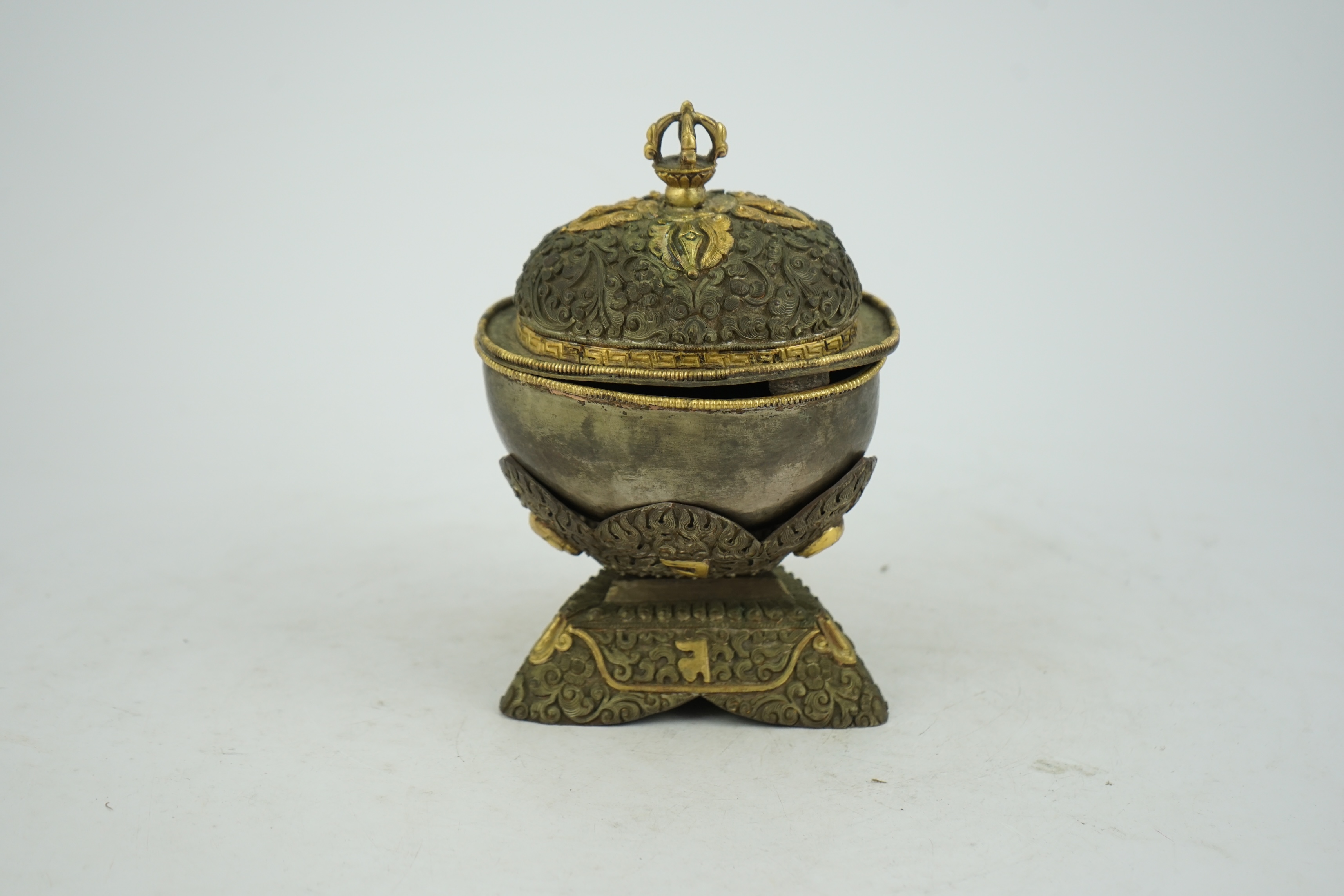 A Tibetan silvered and gilt repoussé copper and bronze capala bowl, late 19th/early 20th century